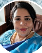 Professional headshot of Dr. Nupur M in blue saree with warm professional smile